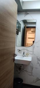 a bathroom with a sink and a mirror at HOTEL PRATIKSHA RESIDENCY in Navi Mumbai