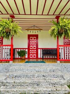a building with a red door and a stone floor at San Remo Ecolodge in Santa Rosa de Cabal