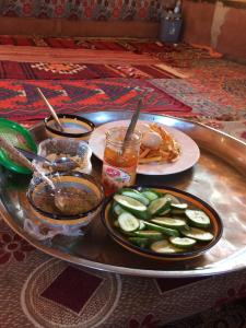 a tray with plates of food on a table at Bedouin Expedition in Wadi Rum