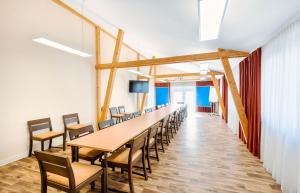 a long conference room with a long table and chairs at ALPHA HOTEL Hermann von Salza in Bad Langensalza +52 photos