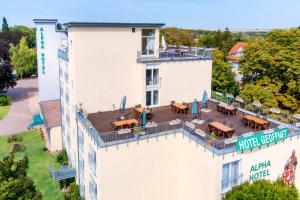 una vista aérea de un patio del hotel con mesas y sillas en ALPHA HOTEL Hermann von Salza en Bad Langensalza