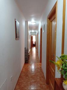 a hallway with white walls and a tile floor at Apartamento Merlin in Roquetas de Mar
