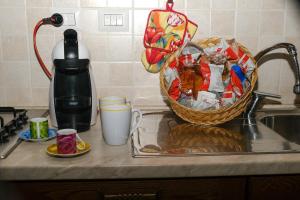 a kitchen counter with a basket of food and a coffee maker at La villa di campagna in Pisticci