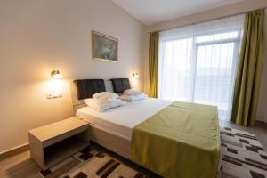 Postel nebo postele na pokoji v ubytování Hotel Nicoleta