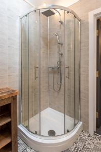 a shower with a glass enclosure in a bathroom at East Farm Cottage in Durham