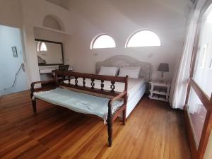 a bedroom with a bed and two windows at Supertubes Villa in Jeffreys Bay