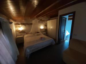 a bedroom with a white bed and a window at Rustico San Leonardo in Cinisi