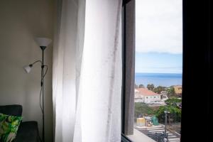a room with a window with a view of the ocean at Apartamento Timple in Icod de los Vinos