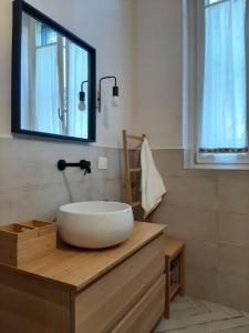 a bathroom with a large bowl sink on a wooden counter at Casa Cybèle in Rovello Porro