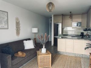 a living room with a couch and a kitchen at Ocean view apartment in Santiago del Teide