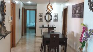 a dining room with a black table and chairs at home zen in Rabat