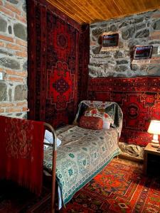 a room with a couch and a table with a lamp at MinAli Boutique Hotel in Sheki