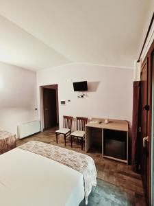 Habitación de hotel con 2 camas, escritorio y TV. en Agriturismo - B&B "La Funicolare", en Francavilla Marittima