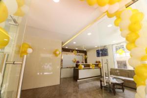a room with yellow balloons on the ceiling at Hotel Sigma Suites in Bangalore