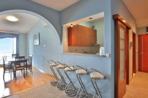 a living room with chairs and a dining room at Plava Vila Beach Apartments Sveti Stefan in Sveti Stefan