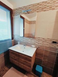 a bathroom with a sink and a mirror at Agriturismo - B&B "La Funicolare" in Francavilla Marittima