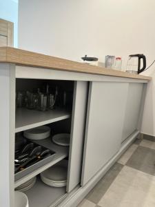 a kitchen with a counter top with dishes at Agroturystyka Liana in Polanica-Zdrój