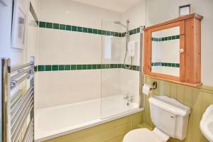 a bathroom with a shower and a toilet and a sink at Host & Stay - The Hayloft in Ilkley