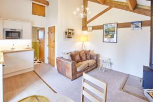 a living room with a couch and a table at Host & Stay - The Hayloft in Ilkley