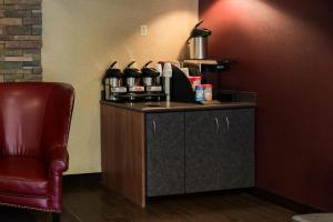 a bar in a room with a chair and a counter at Red Roof Inn Chicago - Joliet in Joliet