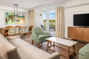 a living room with a couch and a dining room at Club Wyndham Santa Barbara in Pompano Beach
