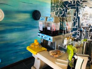 a kitchen with a counter with a coffee maker on it at Cape Nomads in Muizenberg