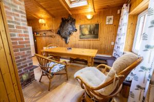 a dining room with a wooden table and chairs at Domek Całoroczny Jaśkowa Chata Leleszki 30 dom 4 in Leleszki