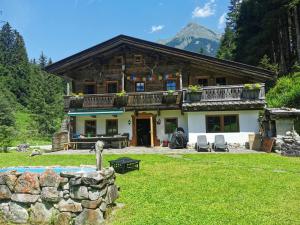 a log house with a mountain in the background at Ferienhaus Gaishütte in Ginzling