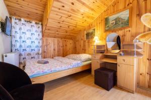 a bedroom with two beds in a wooden room at Domek Całoroczny Jaśkowa Chata Leleszki 30 dom 4 in Leleszki +31 photos