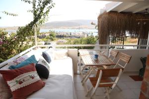 a balcony with a bed and a table at Parva Port in Alacati