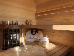 a sauna with a shelf with a bottle of wine at Chalet Velika Planina with Sauna - I FEEL ALPS in Stahovica