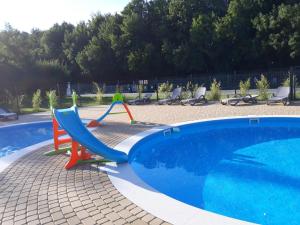 a slide next to a swimming pool at Pokój 31 Domino Family Dominikana in Sianozety