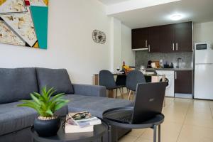 a living room with a couch and a laptop on a table at Apartamento Poleo in Icod de los Vinos