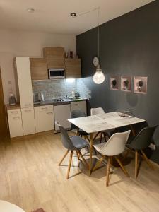 a kitchen and dining room with a table and chairs at Dolní Morava - Apartmány in Dolní Morava
