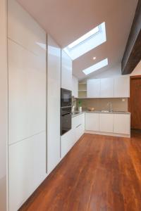 a kitchen with white cabinets and a skylight at Studio 474 in Colombo