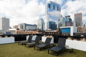 a row of chairs on a rooftop with a city skyline at Sonder at SECOND & SECOND in Minneapolis