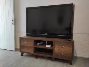 a flat screen tv on a wooden entertainment center at Mystic Guest House Famagusta in Famagusta