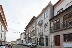 a row of buildings on a street with parked cars at Porta do sol Luxury Apartment in Porto