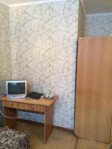 a room with a desk with a computer on a wall at Hotel Belebey in Belebey