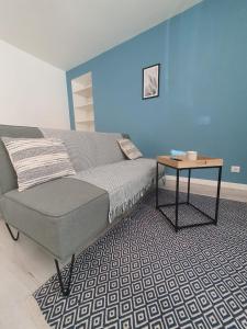 a bedroom with a bed and a table on a rug at APPARTEMENT HYPER CENTRE - Place du Minage in Angoulême