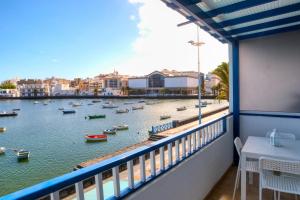 a balcony with a view of a body of water with boats at Casa Jolatero Ventana al Charco in Arrecife