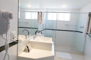 a bathroom with a shower and a sink at Casablanca Center Hotel in Petrópolis