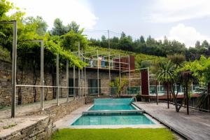 a house with a swimming pool and a balcony at Vila Marim Country Houses in Mesão Frio