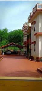 a view of a building with a red brick road at Shree Homestay in Manipala