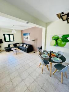 a living room with a table and a couch at Sunny Villa in Kissamos