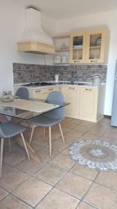 a kitchen with a table and chairs in a kitchen at Mary's Home in Madonna della Costa