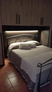 a bedroom with a large bed with a white comforter at Mary's Home in Madonna della Costa