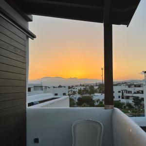 a view of the sunset from the balcony of a house at Cabo Negro, La Cassia 2 bedrooms appartment , shared pool , 150 m away from the Beach, and Golf course in Martil +7 photos