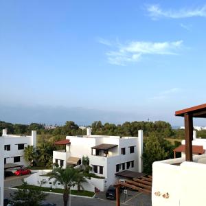 a view of a white building with a parking lot at Cabo Negro, La Cassia 2 bedrooms appartment , shared pool , 150 m away from the Beach, and Golf course in Martil