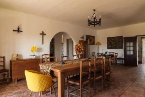 a dining room with a wooden table and chairs at Monte Ribeira de Mures in Évora